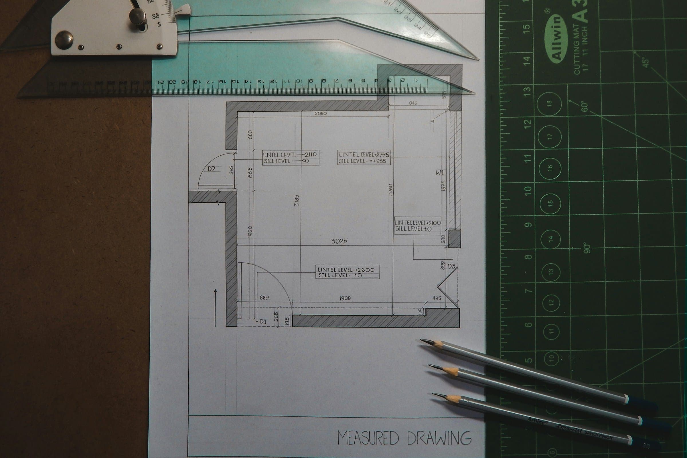 Floor plan drawing with pencils. Project photography is in progress.